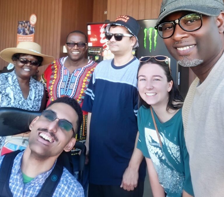 4 men, 1 in a powerchair, and 2 women are at the WA State Fair.
