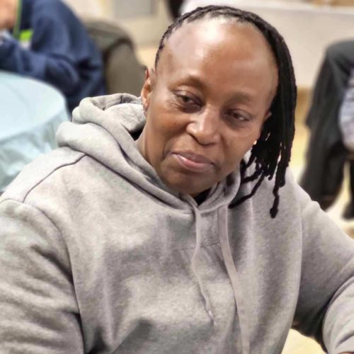 A woman wearing a gray hoodie sweatshirt